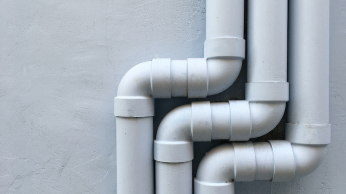 Three White Pipes Running Next To Each Other