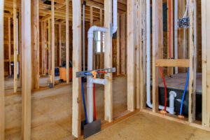 Inside of New Home Construction Showing New Pipes Installed in House Frame