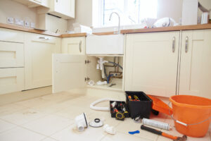 Tools and Parts on Floor of Kitchen as Plumbing is Newly Installed